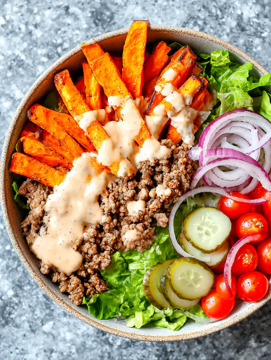 A bowl of food with meat, onions, and tomatoes.