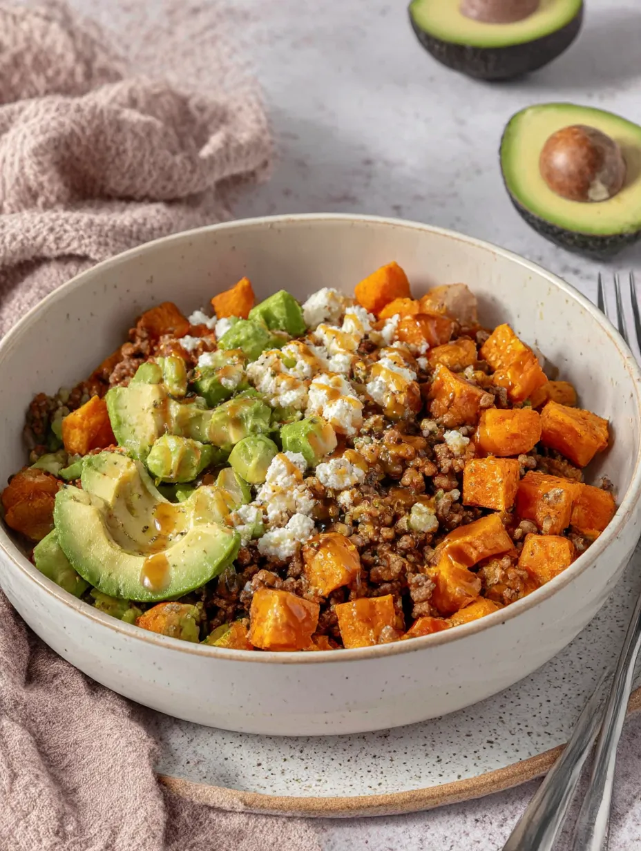A bowl of food with a fork next to it.