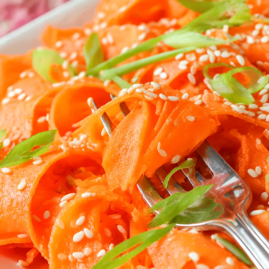 A fork is stuck in a plate of food.
