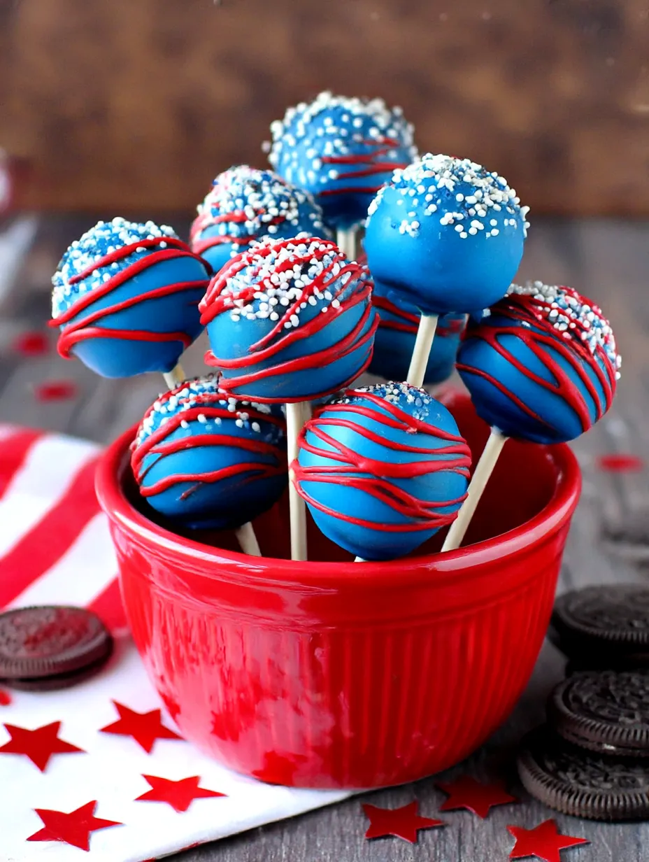 A bowl of red white and blue oreo pops.