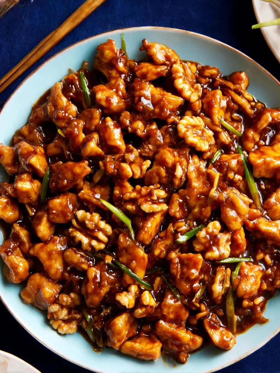 A plate of stir fry chicken with yellow bean paste.