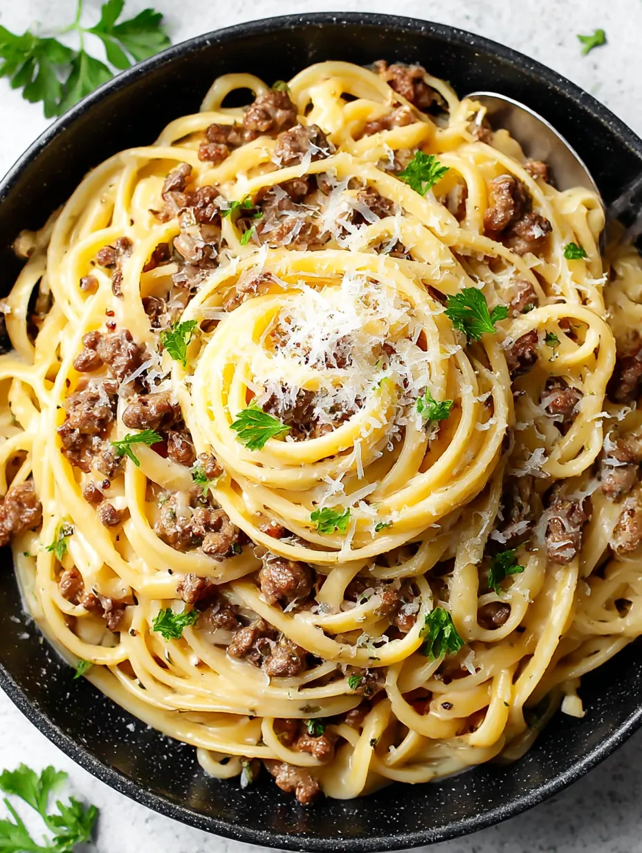 A bowl of pasta with meat and cheese.