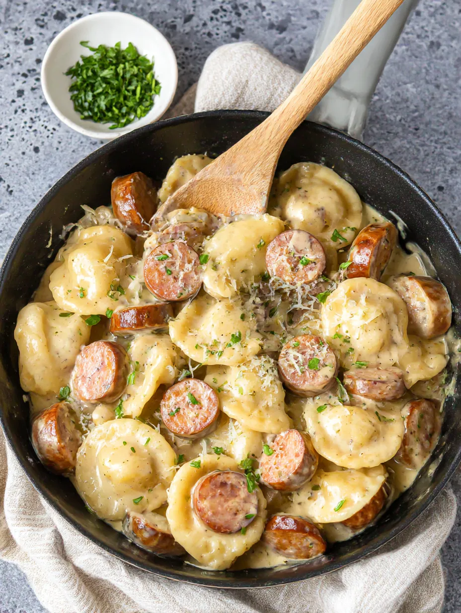 A skillet filled with sausage and pasta.