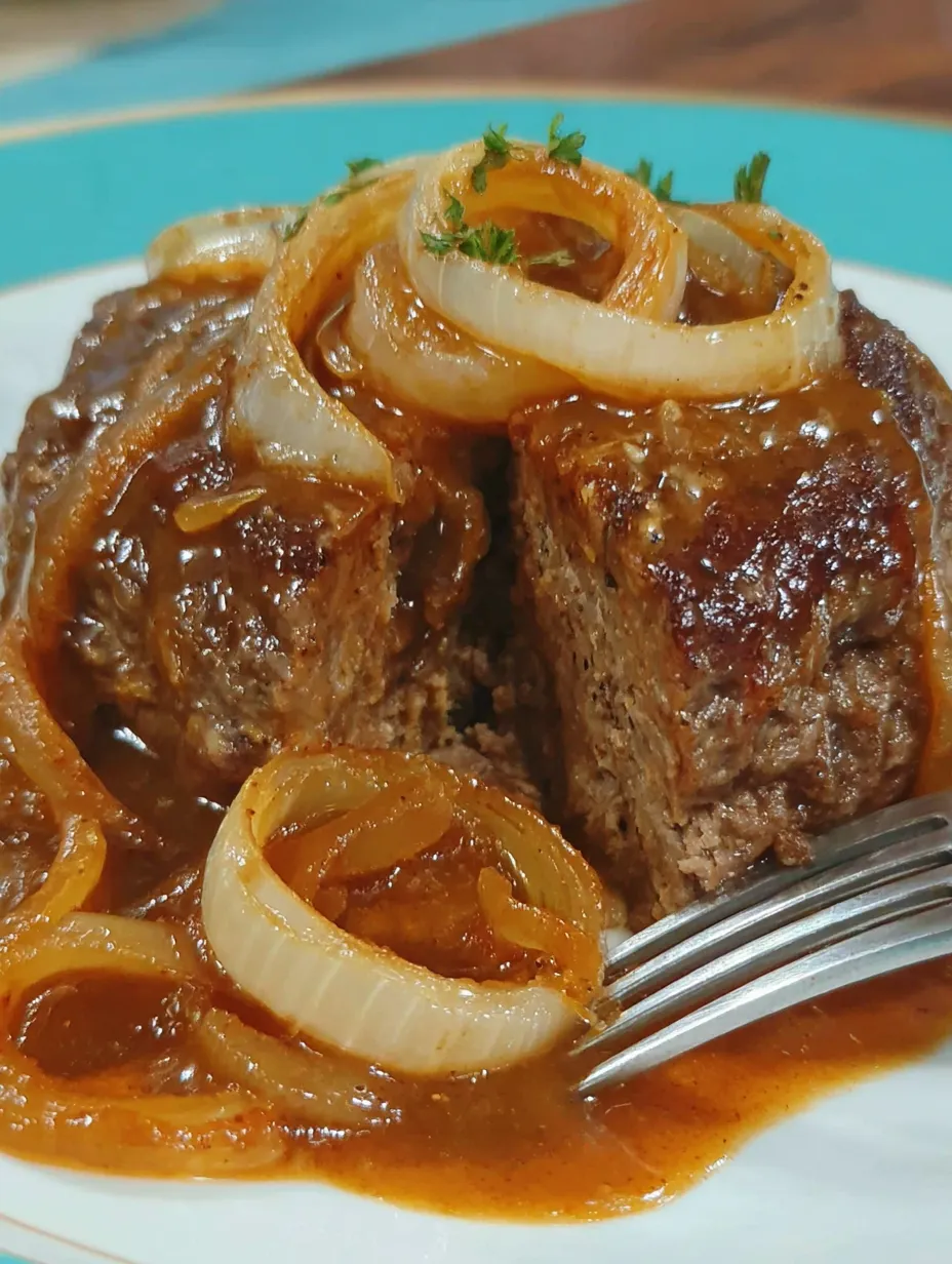 A piece of meat with onions on top.