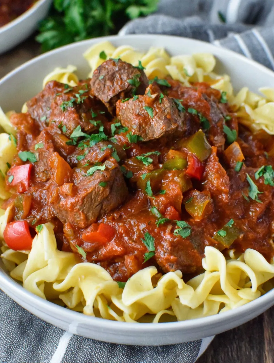 A bowl of pasta with meatballs and sauce.