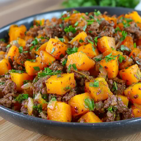 A bowl of savory beef and sweet potato hash.