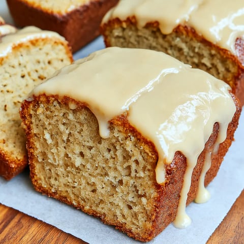A slice of banana bread with honey drizzled on top.