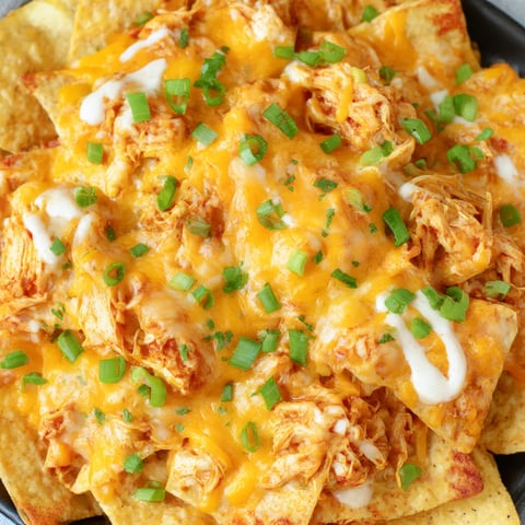 Buffalo chicken nachos on a plate.
