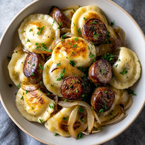 A bowl of food with sausage and onions.