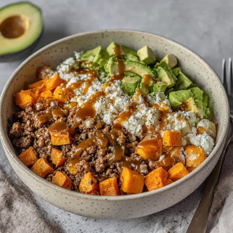 A bowl of food with a fork next to it.