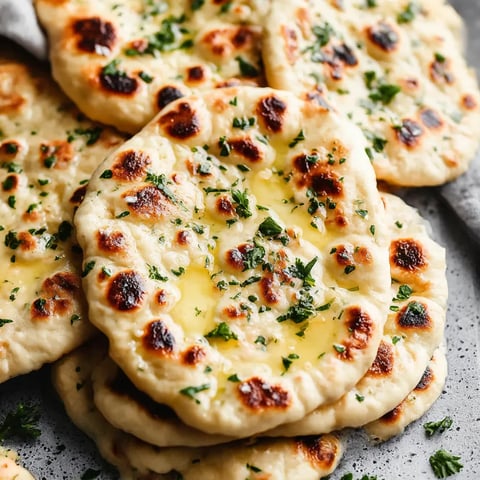 A stack of garlic naan bread.