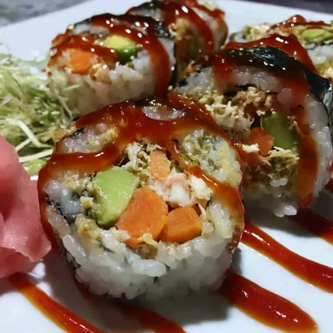 A plate of sushi with a California roll.