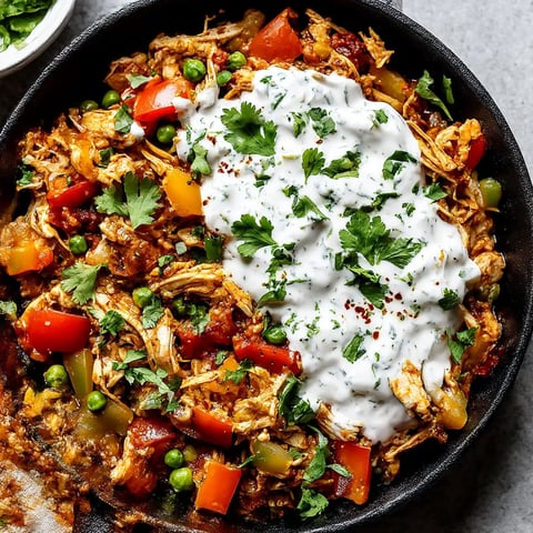 A dish of Mexican Pulled Chicken with white sauce.