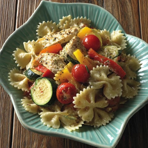 A plate of pasta, chicken, and vegetables.