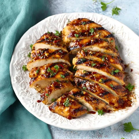 A plate of chicken with sauce on it.