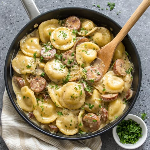 A skillet filled with pasta and sausage.