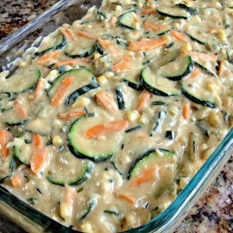 A dish made with zucchini, corn, and carrots.