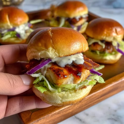 A person holding a small sandwich.