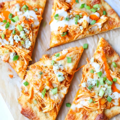 A pizza with chicken and cheese on it.