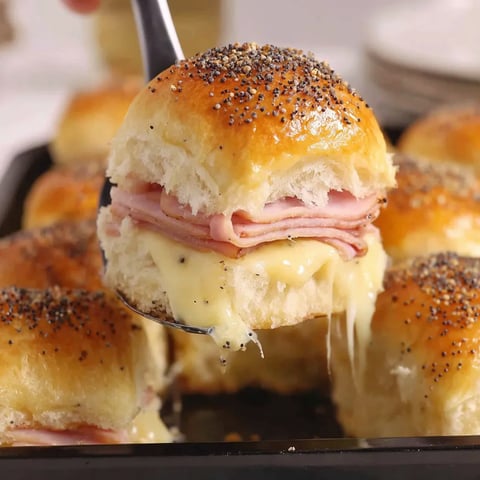 A sandwich is being cut into smaller pieces.