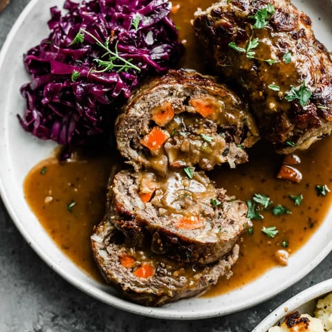 Ein weißer Teller mit einer Beilage aus Kartoffeln und Sauce.