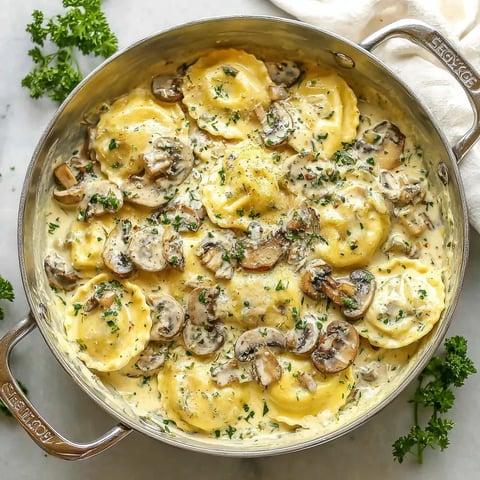A pot of pasta with mushrooms and herbs.