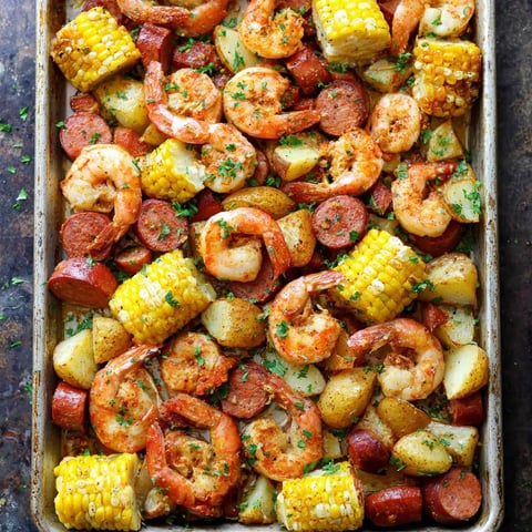 A pan of shrimp, corn, and potatoes.