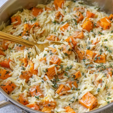 A bowl of food with a spoon in it.